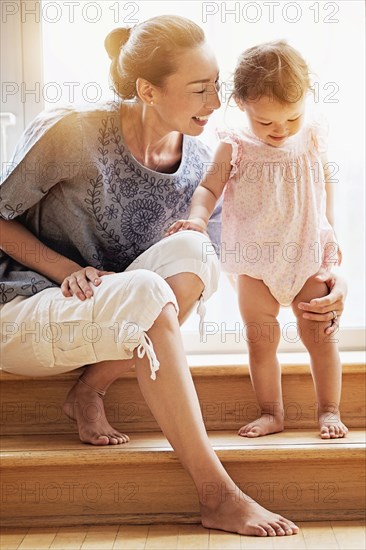 Mother and baby daughter on steps