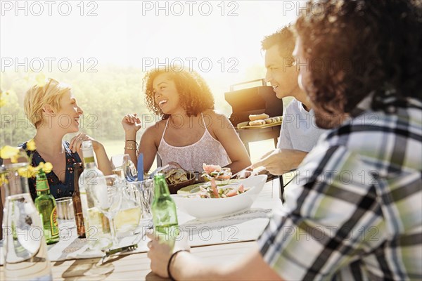 Friends eating together outdoors