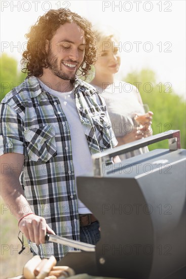 Caucasian man grilling at barbecue