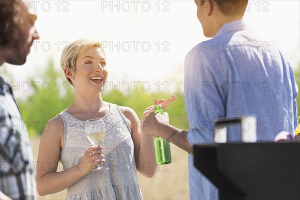 Friends talking at party outdoors