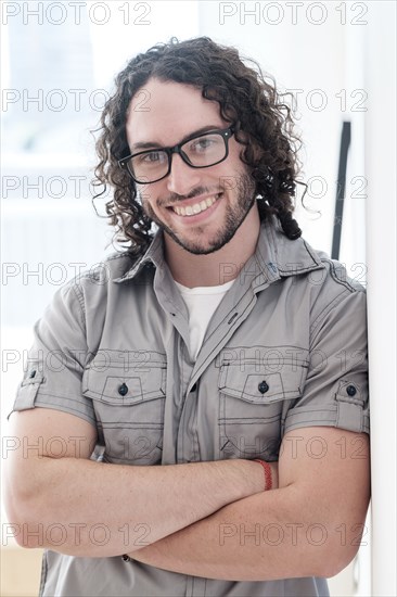 Caucasian man smiling with arms crossed