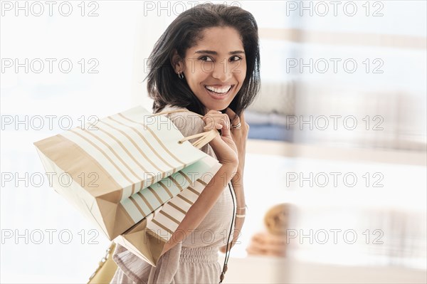 Hispanic woman carrying shopping bags