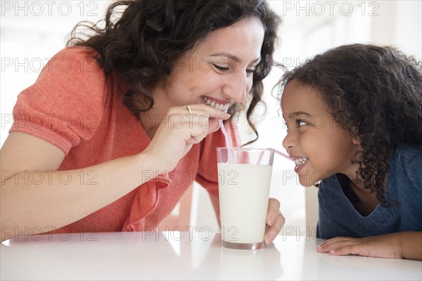 Mother and daughter drinking milk