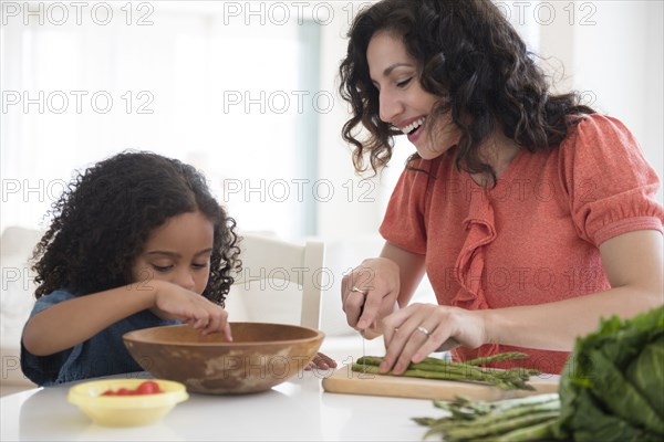 Mother and daughter chopping vegetables