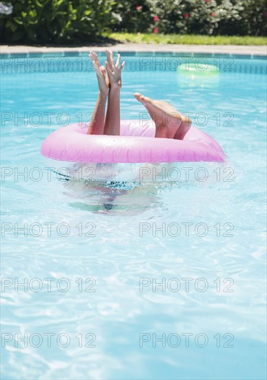 Caucasian woman playing in swimming pool