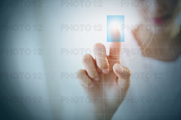 Close up of Hispanic woman touching digital screen