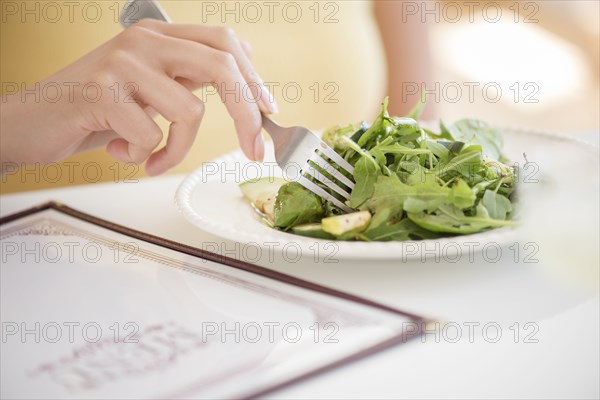 Hispanic woman eating salad