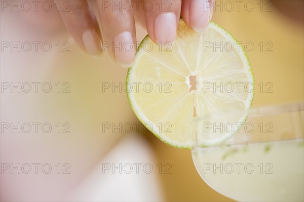 Hispanic woman garnishing cocktail