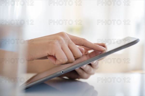Hispanic woman using digital tablet