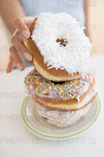 Hispanic woman choosing donut