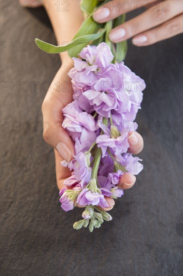 Hispanic woman holding flowers