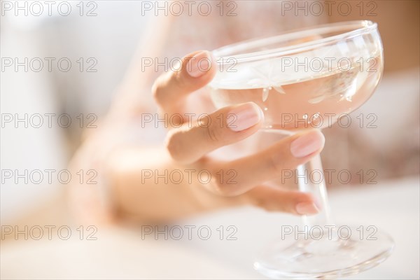 Hispanic woman drinking cocktail