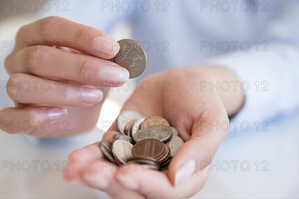 Hispanic woman counting coins