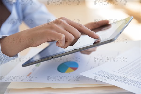 Hispanic businesswoman using digital tablet