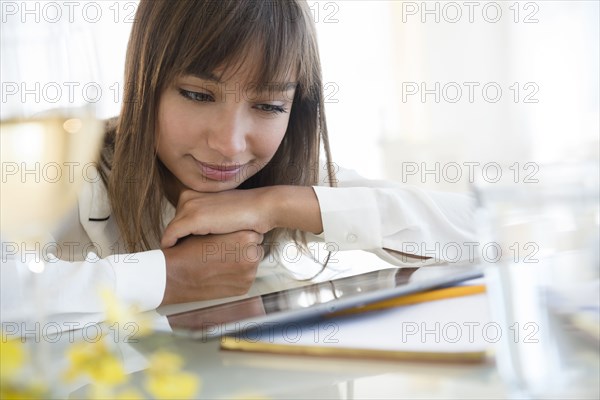 Mixed race woman using digital tablet