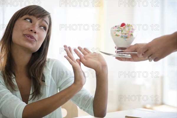 Woman refusing unhealthy ice cream