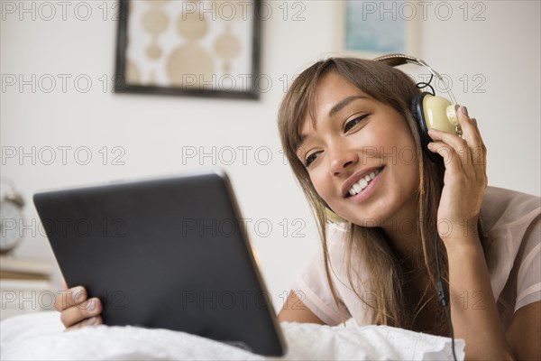 Mixed race woman listening to headphones