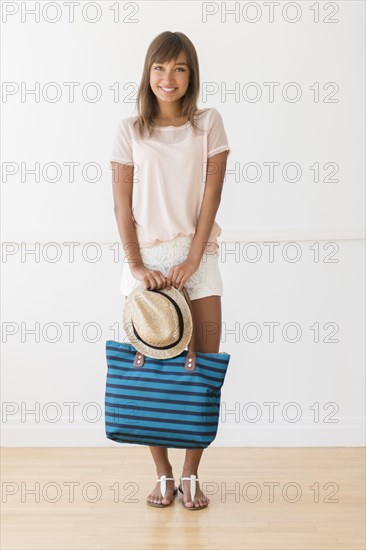 Mixed race woman holding tote bag