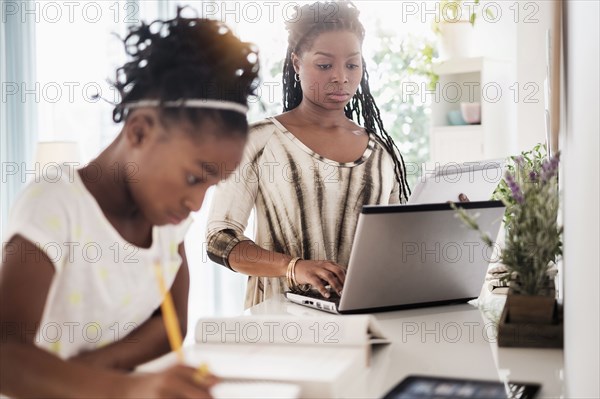 Black mother and daughter studying