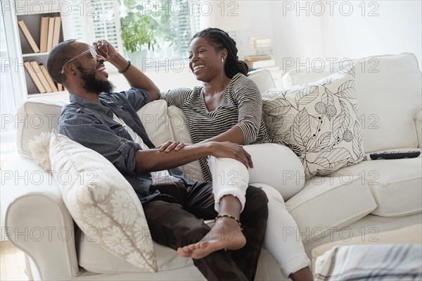 Black couple talking on sofa