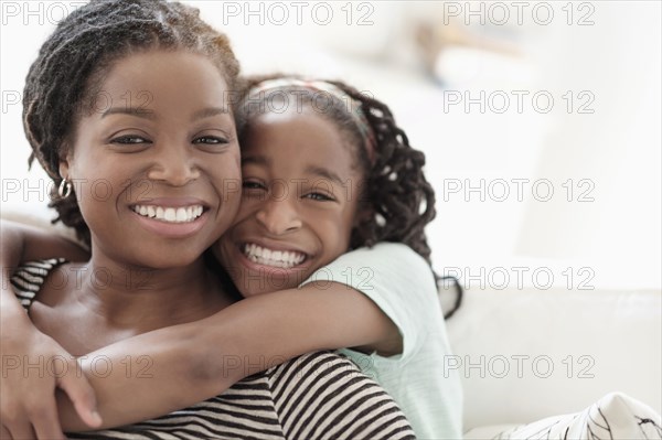 Black mother and daughter hugging