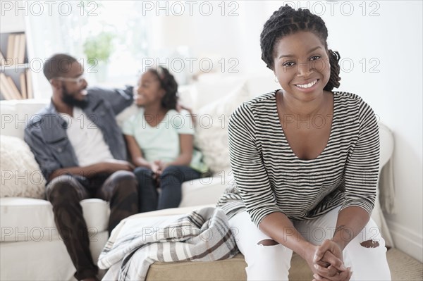 Black mother sitting in living room