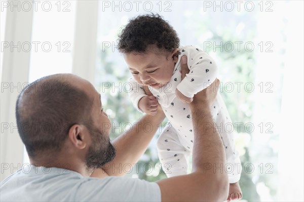 Father playing with baby son