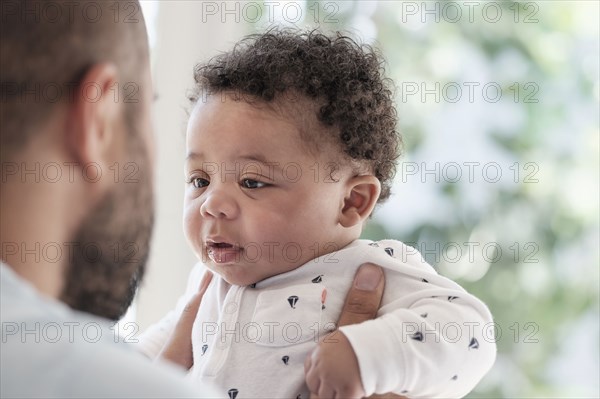 Father holding baby son