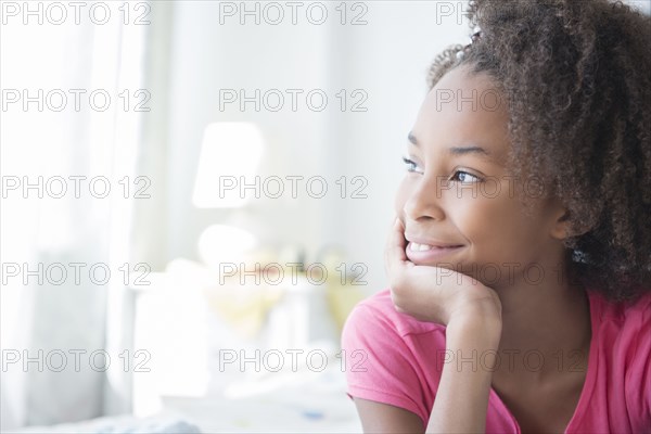 Mixed race girl smiling indoors