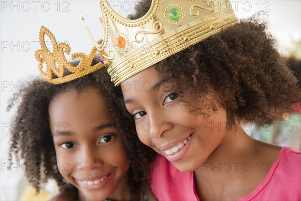 Mixed race sisters playing dress up