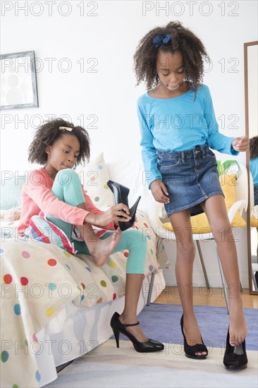 Mixed race sisters playing dress up