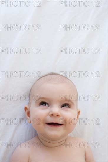 Caucasian baby girl laying on blanket