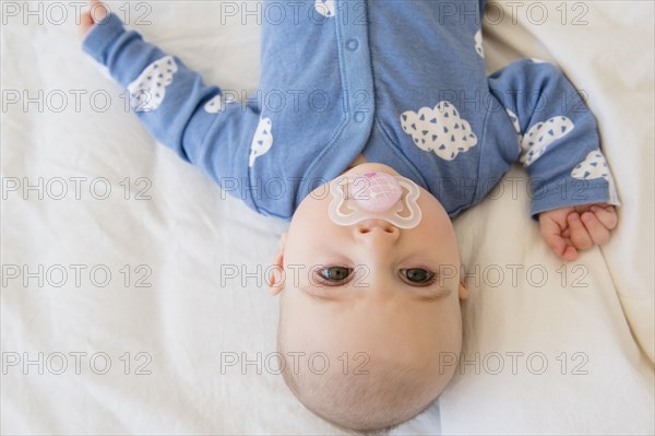 Caucasian baby girl with pacifier