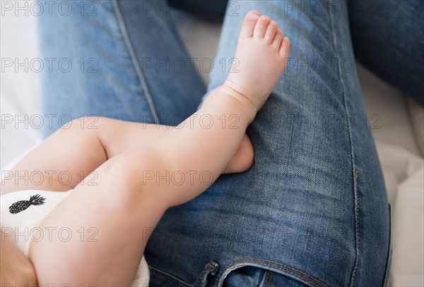 Caucasian mother holding baby daughter