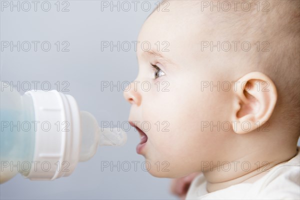 Caucasian baby girl drinking bottle