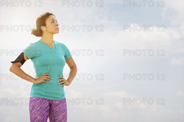 Mixed race runner standing outdoors