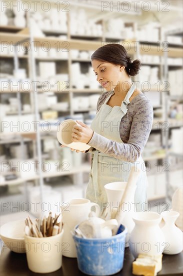 Mixed race potter working in workshop