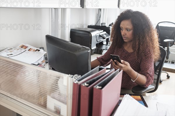 Black businesswoman working at office desk