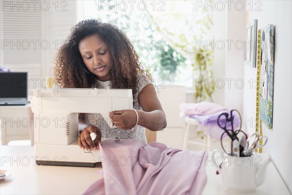 Black woman using sewing machine