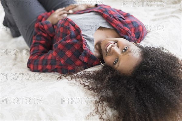 Black woman laying on bed