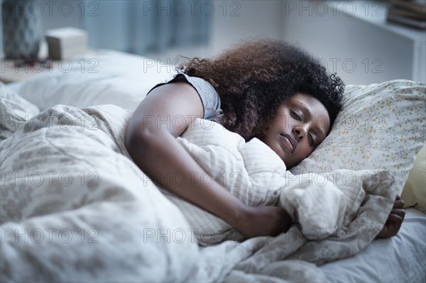 Black woman sleeping in bed