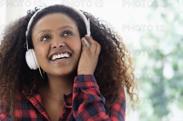 Black woman listening to headphones