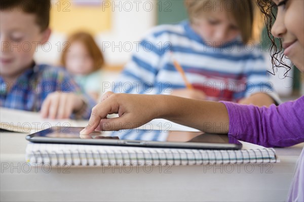 Student using digital tablet in classroom