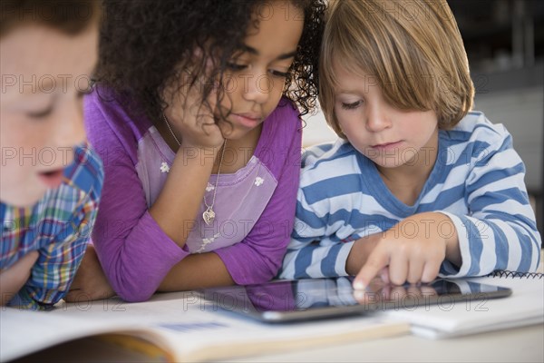 Students using digital tablet in classroom