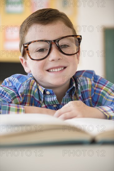 Caucasian student wearing eyeglasses in classroom