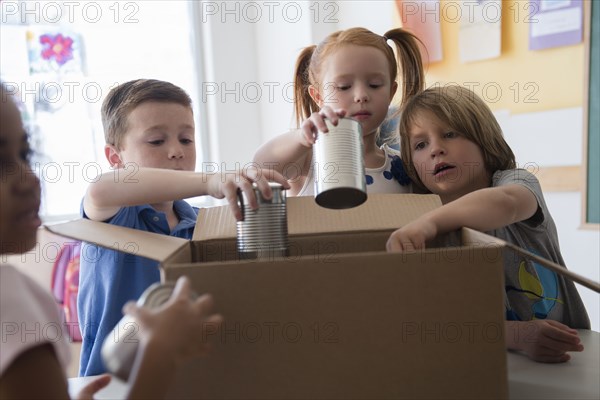 Students donating canned goods in classroom