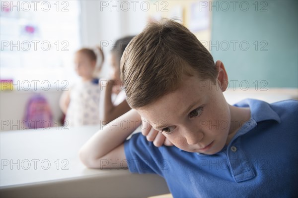 Sad student leaning on desk