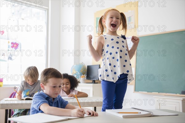 Student shouting at desk in classroom