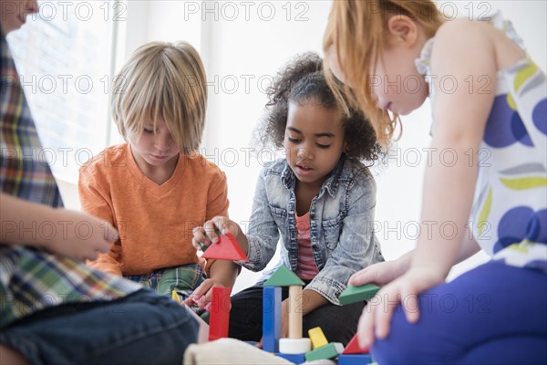 Children playing with blocks on floor