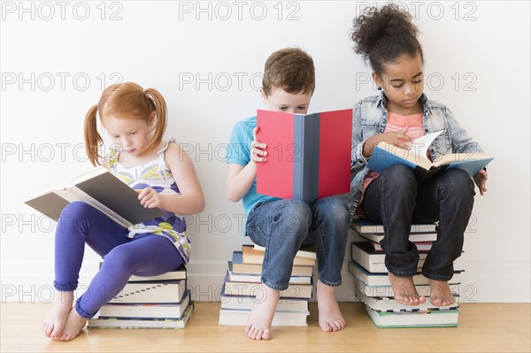 Barefoot students reading books